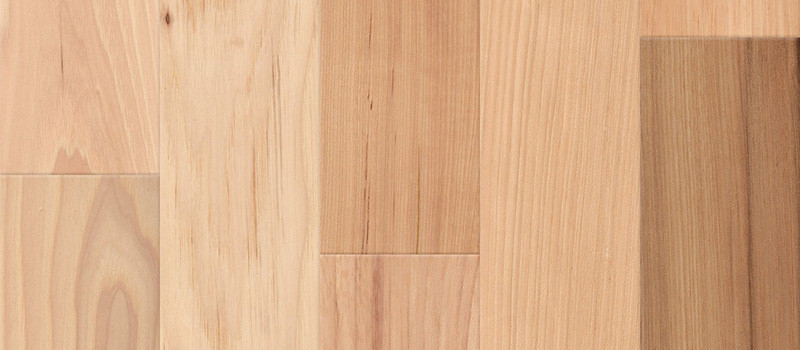 Character-rich rustic Hickory hardwood flooring sample highlighting dramatic natural colour variations from pale blonde to deep tan planks.