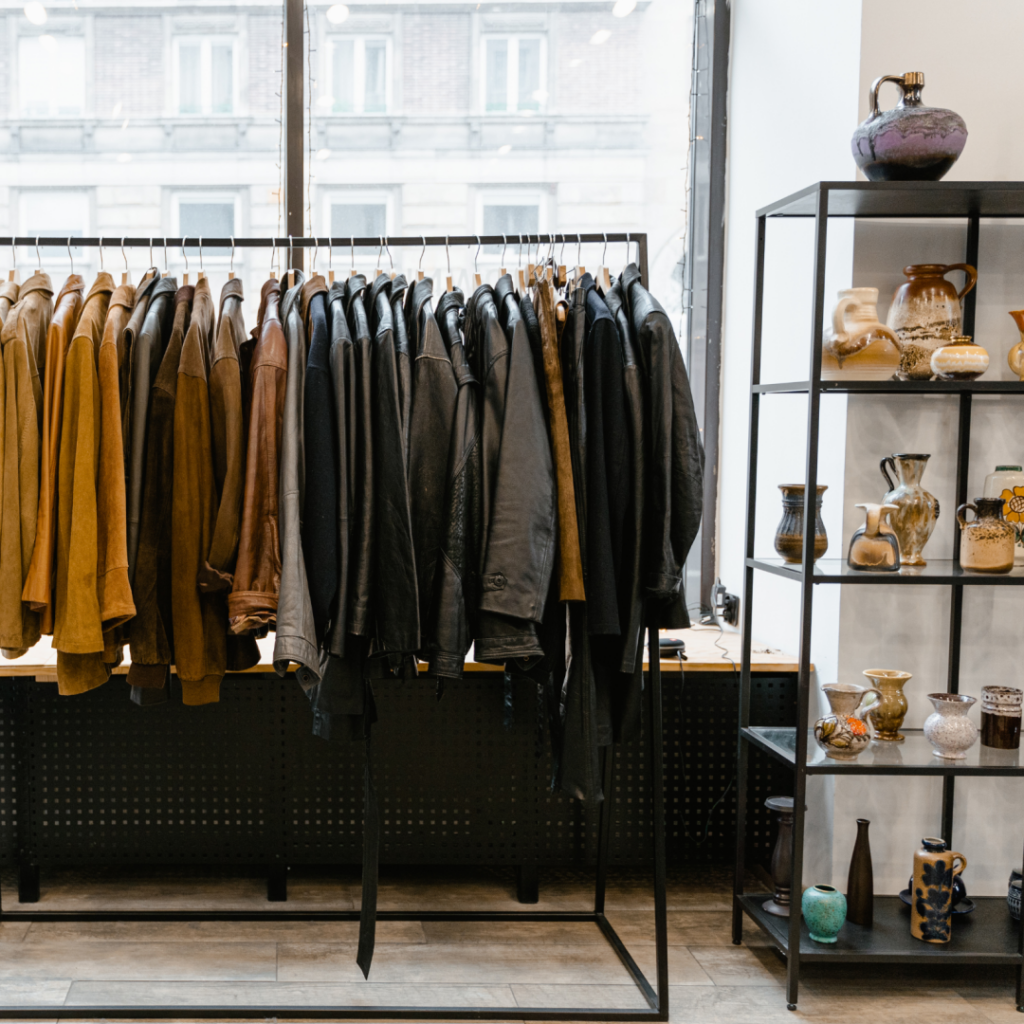 Dark wood flooring in a modern clothing retail store with leather jackets on display